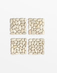 Beachstone Stones Coasters (Set of 4) - Sand Color | Image 1 | From the BeachStone Collection | Skillfully crafted with natural stones for long lasting use | Available in gray color | texxture home